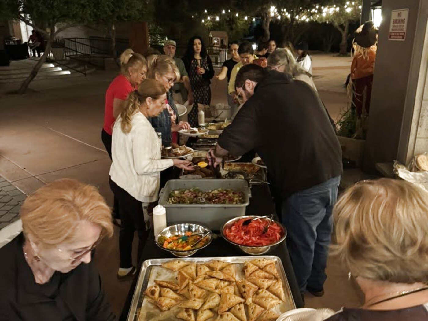 Trays of boureg and lahmajoun on the festival serving line